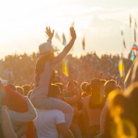BIG ZAVIDOVO, RUSSIA - JULY 5: People cheering at open-air rock festival "Nashestvie" on July 5, 2014 in Big Zavidovo, Russia. "Nashestvie" is the biggest rock festival in Russia, more 200000 visitors